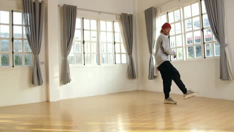 young asian male breakdancer dancing, slow motion