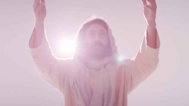 Backlit Portrait Of Man Wearing Robes With Long Hair And Beard Representing Figure Of Jesus Christ Praying Or Preaching 1