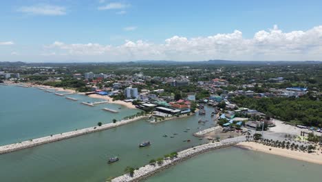 sattahip fishing village with vessels at port. aerial drone tilt down shot, thailand.