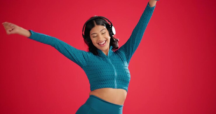 Young Woman Dancing and Listening to Music with Headphones
