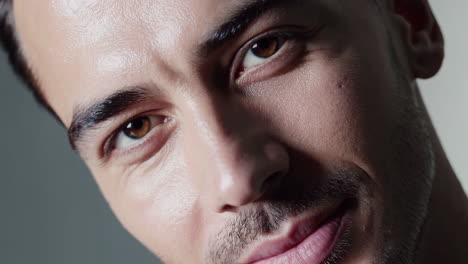 close-up portrait of a smiling man with brown eyes