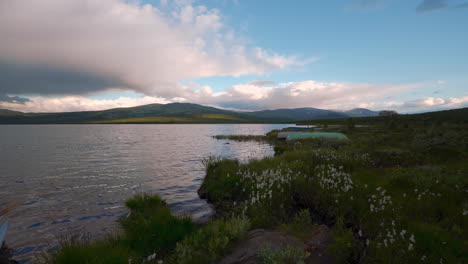 Scenic sunset at a lake in the Arctic Circle, Norway. Cinemagraph, highlands mountains and calm water.