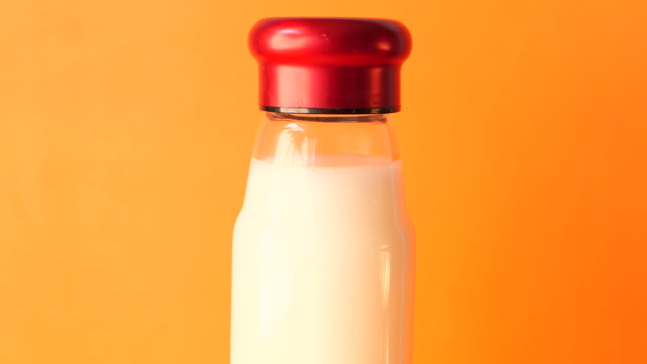 Glass Bottle of Milk with Red Cap