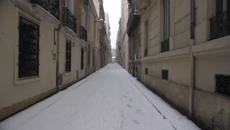 snow-covered road in montpellier old streets during a snowy day. france winter