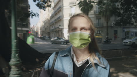 Outdoor-urban-portrait-of-walking-woman-in-mask