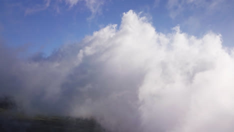 drone view of high white clouds moving over the haleakala volcano on maui, hawaii at daylight