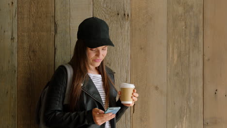 student, coffee and reading messages on phone