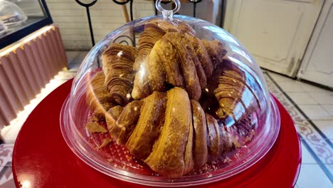 delicious croissants under a clear dome