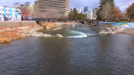 aerial over truckee river in reno with a push towards a pedestrian bridge