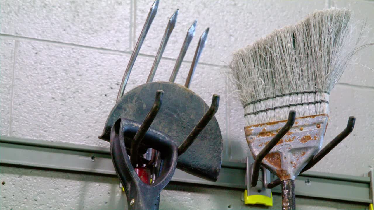 Rake and Broom on wall dolly right to left
