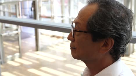 a japanese businessman descends on an escalator at the airport in israel