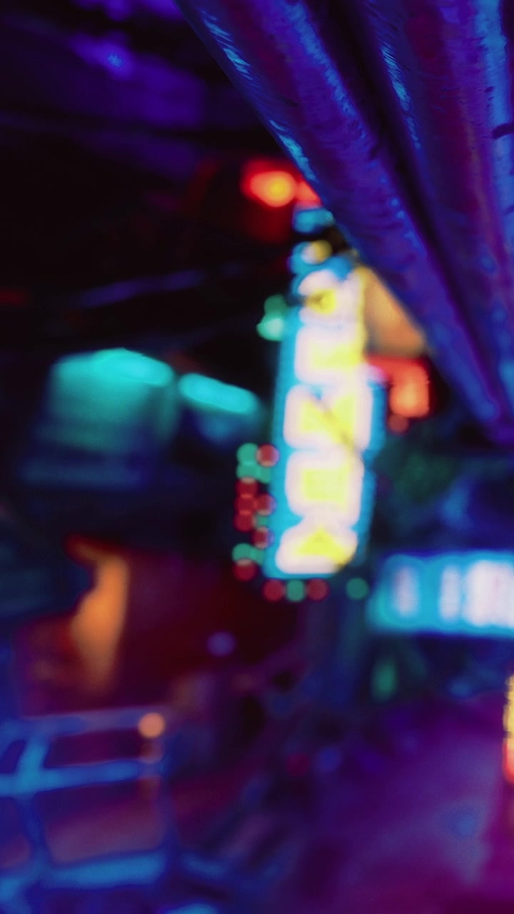 Neon lights illuminate alleyway at night in urban setting