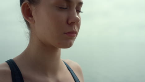 portrait girl meditating outdoors. woman practicing yoga sitting lotus pose