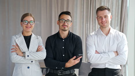 young confident self-sure office team stand smiling in front of camera. business colleagues ready for new challenges and tasks.