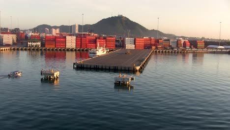 Aerial-view-slowly-passing-a-commercial-shipping-pier-on-a-calm-day