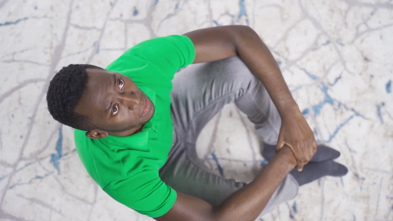 Depressed african young man feeling helpless and powerless, feeling frustrated.