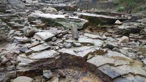 broken rough wet stone pathway cascading rainfall overcast autumn hiking trail