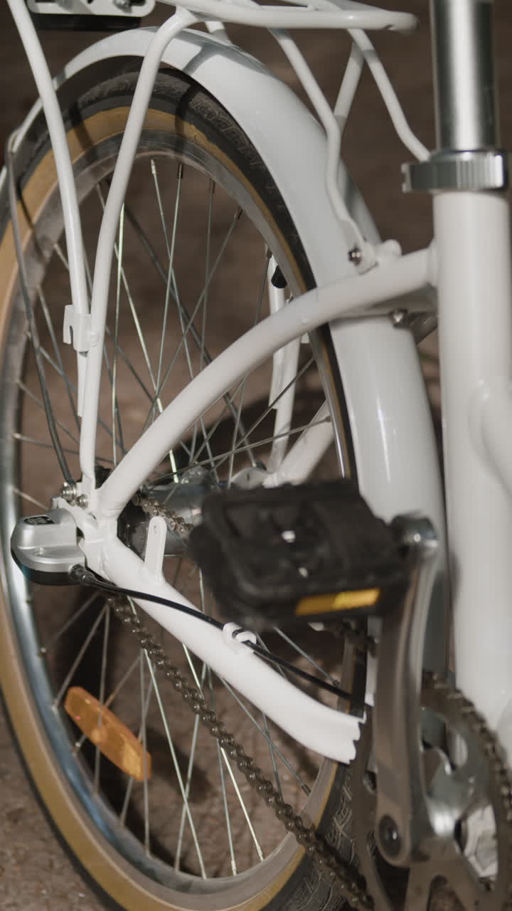 Close-up of a white bicycle wheel and pedal