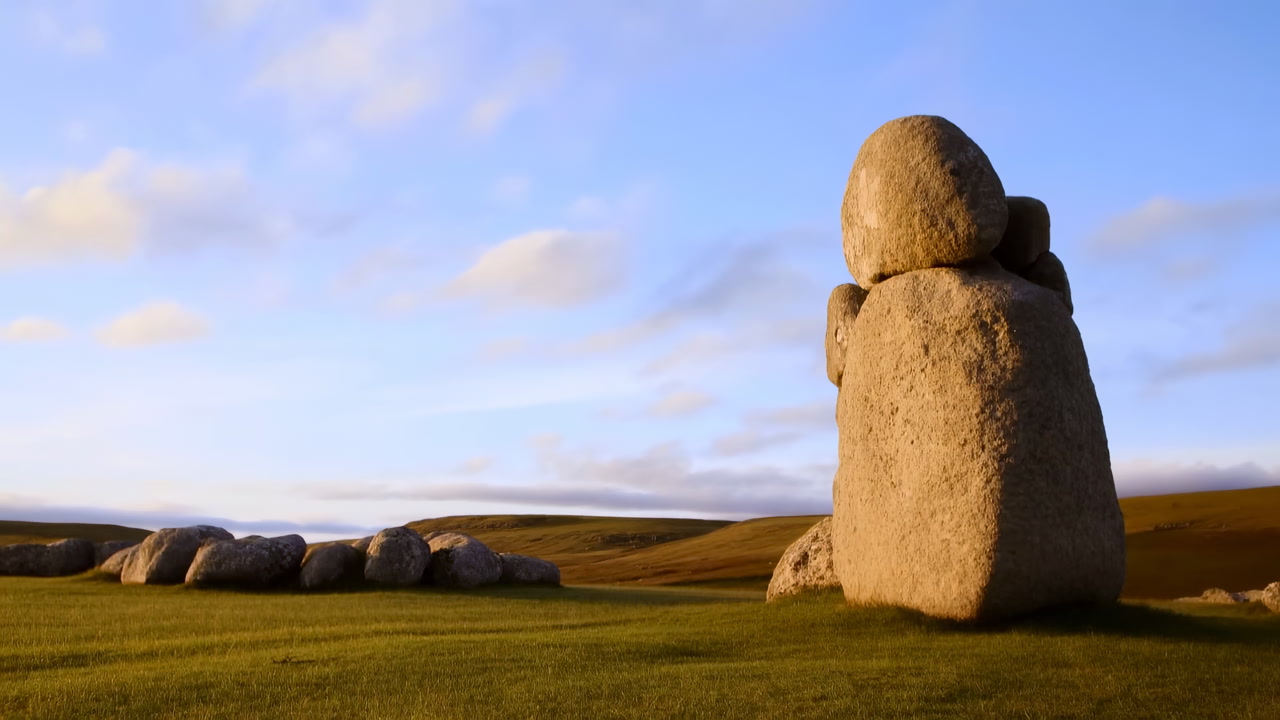 Golden Hour Standing Stones On Moor, Cinematic Drone Sweep Reveals Solitary Megalith And Low Stone Row
