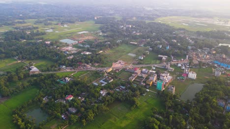 establishing shot of the sylhet apartments with agricultural land beside