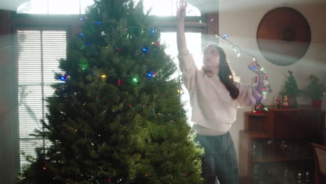 Woman Decorating a Christmas Tree with Colorful Lights