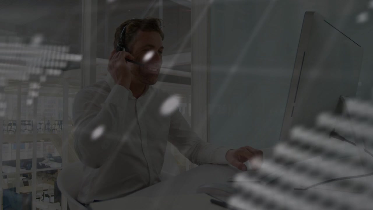 Male IT support monitoring, dotted map and terminal text causing headset adjustment to troubleshoot