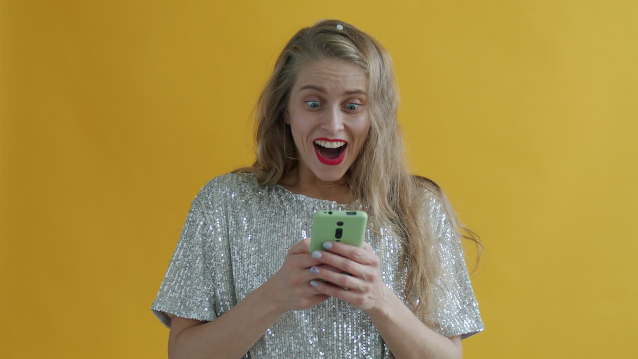 Woman Celebrating with Phone and Confetti