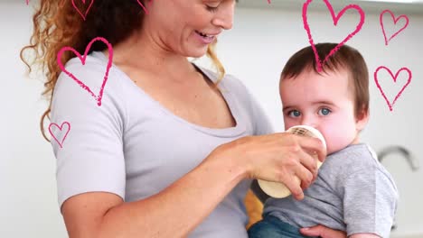 Animation-of-falling-hearts-over-caucasian-mother-with-her-baby