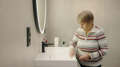 elderly woman in a modern bathroom