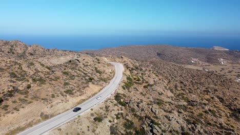 scenic coastal road close to magganari beach, ios island, greece