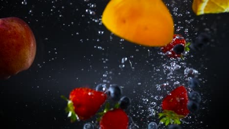 Mixed-fruit-falling-into-watter