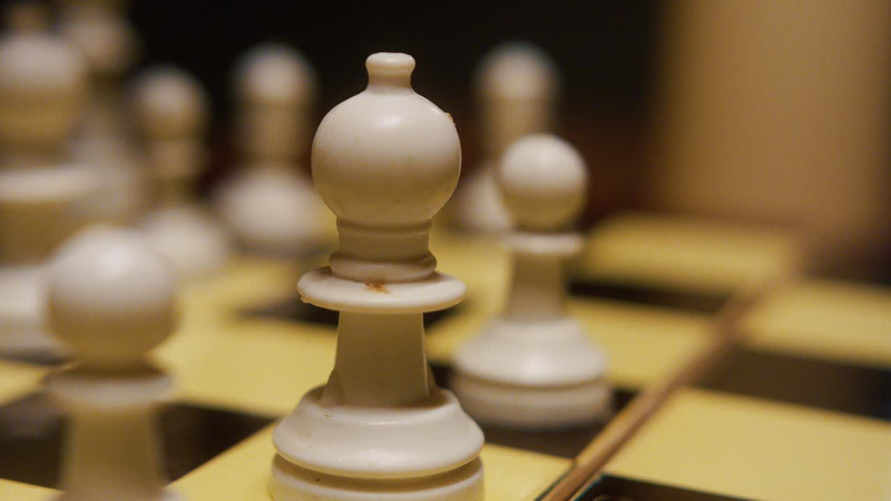 Close-up of chess game play showing strategic moves with focus on pieces