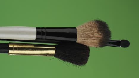 horizontal rotation of set makeup brush, on green screen. close-up.