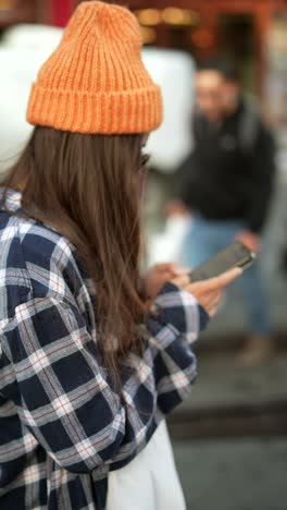 woman using phone in city