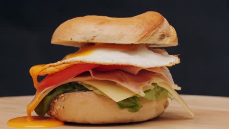 bagel sandwich brunch, lunch plate of a bagel with smoked salmon and cream cheese and ham, close up morning cafe menu.