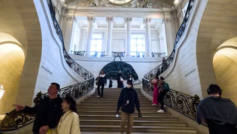 visitors ascending and descending a grand staircase