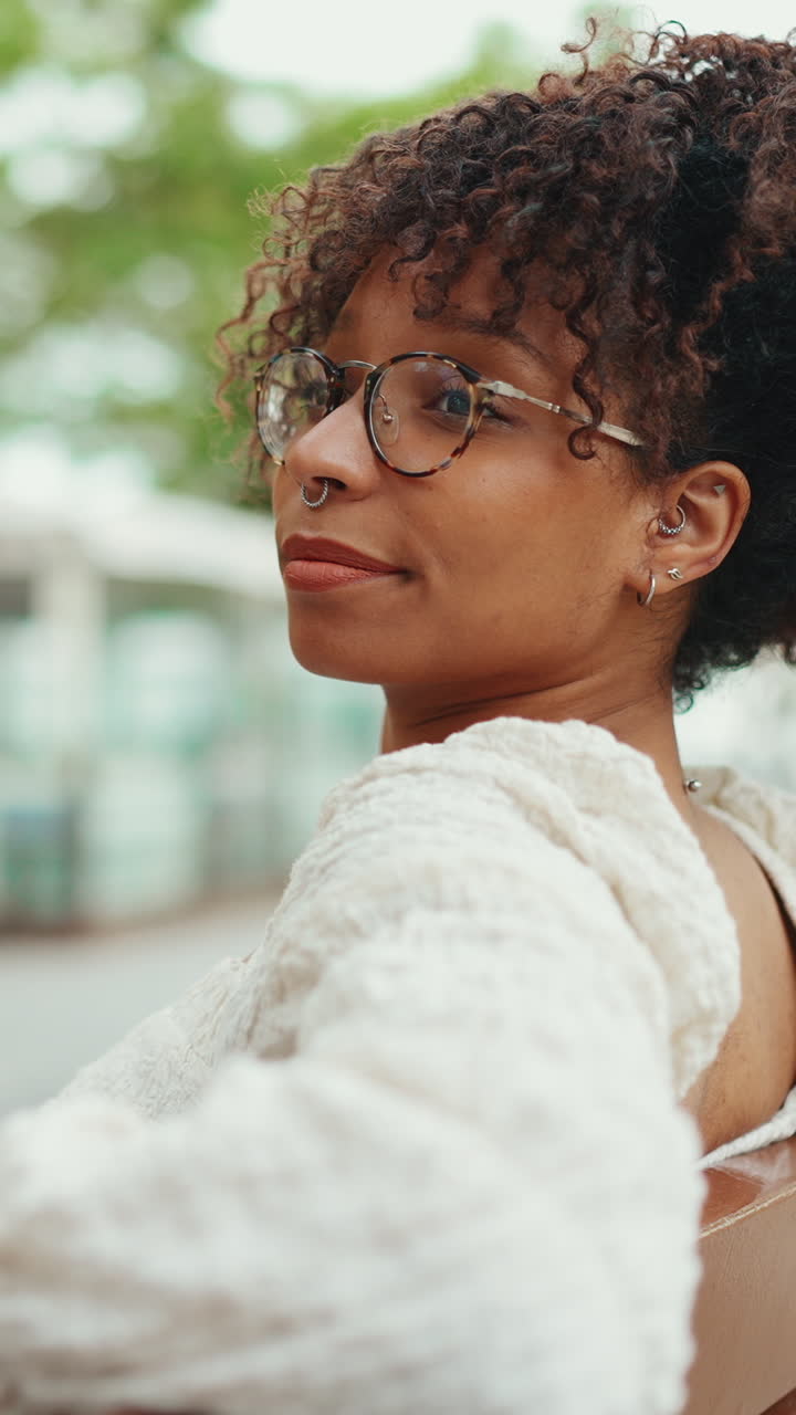Portrait of a woman with curly hair and glasses