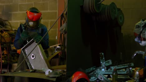 worker polishing metal casting in foundry workshop 4k