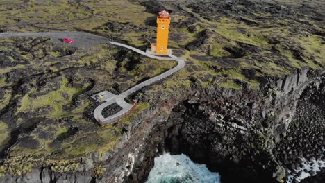 Aerial-of-Svörtuloft-Lighthouse-at-a-rocky-coast-with-cliffs-in-Iceland