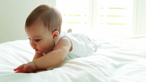 Cute-baby-girl-playing-on-bed