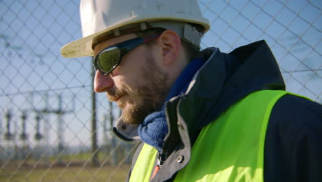 workman relaying information to colleagues over radio