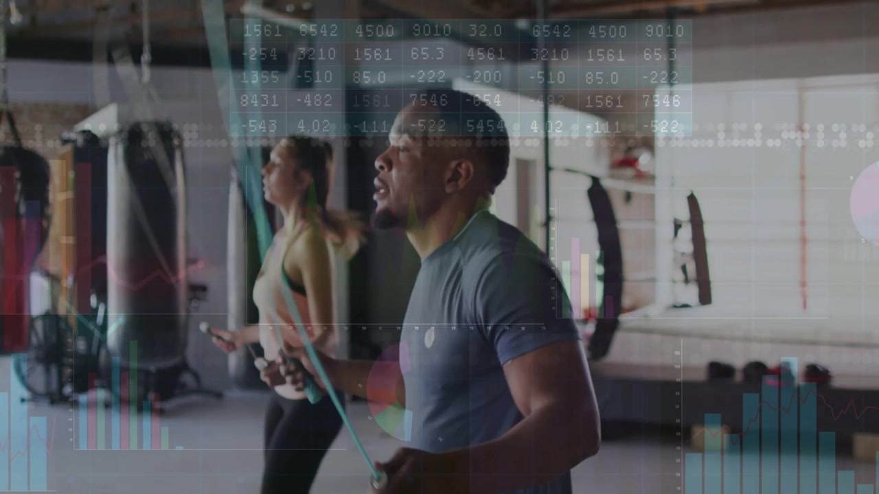 Man and woman starting skipping in gym, data charts overlaying jump ropes, showing cardio metrics