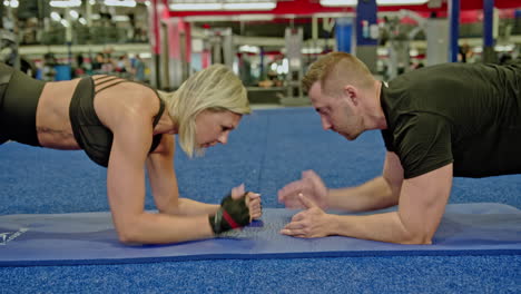 woman and man train on sports training equipment in a fitness gym