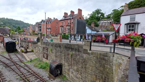 train moving through scenic llangollen, wales