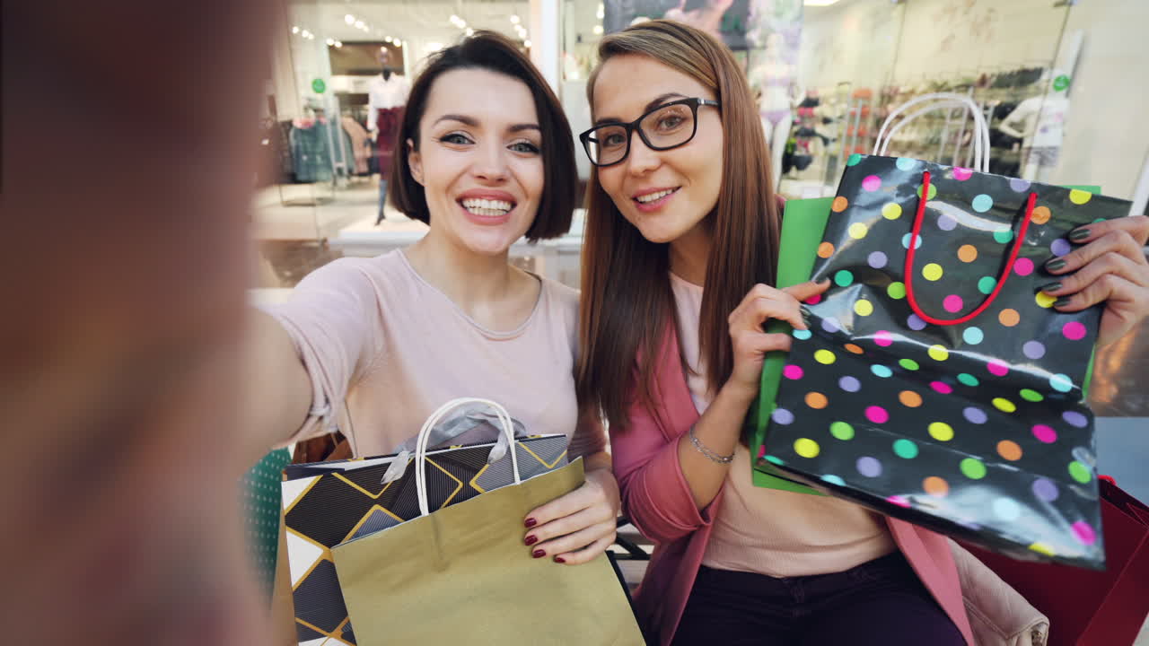 Two Happy Friends Enjoying a Shopping Spree at the Mall
