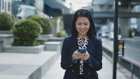 businesswoman using smartphone in city