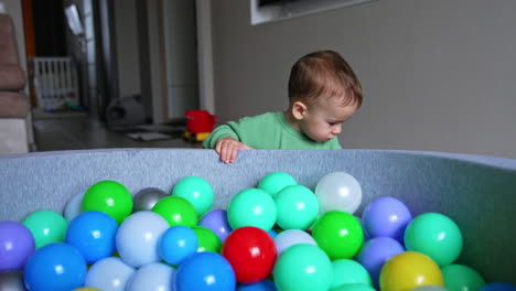 toddler playing in a ball pit