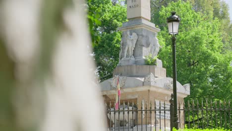 revealing dolly shot showing fenced statue in madrid, spain