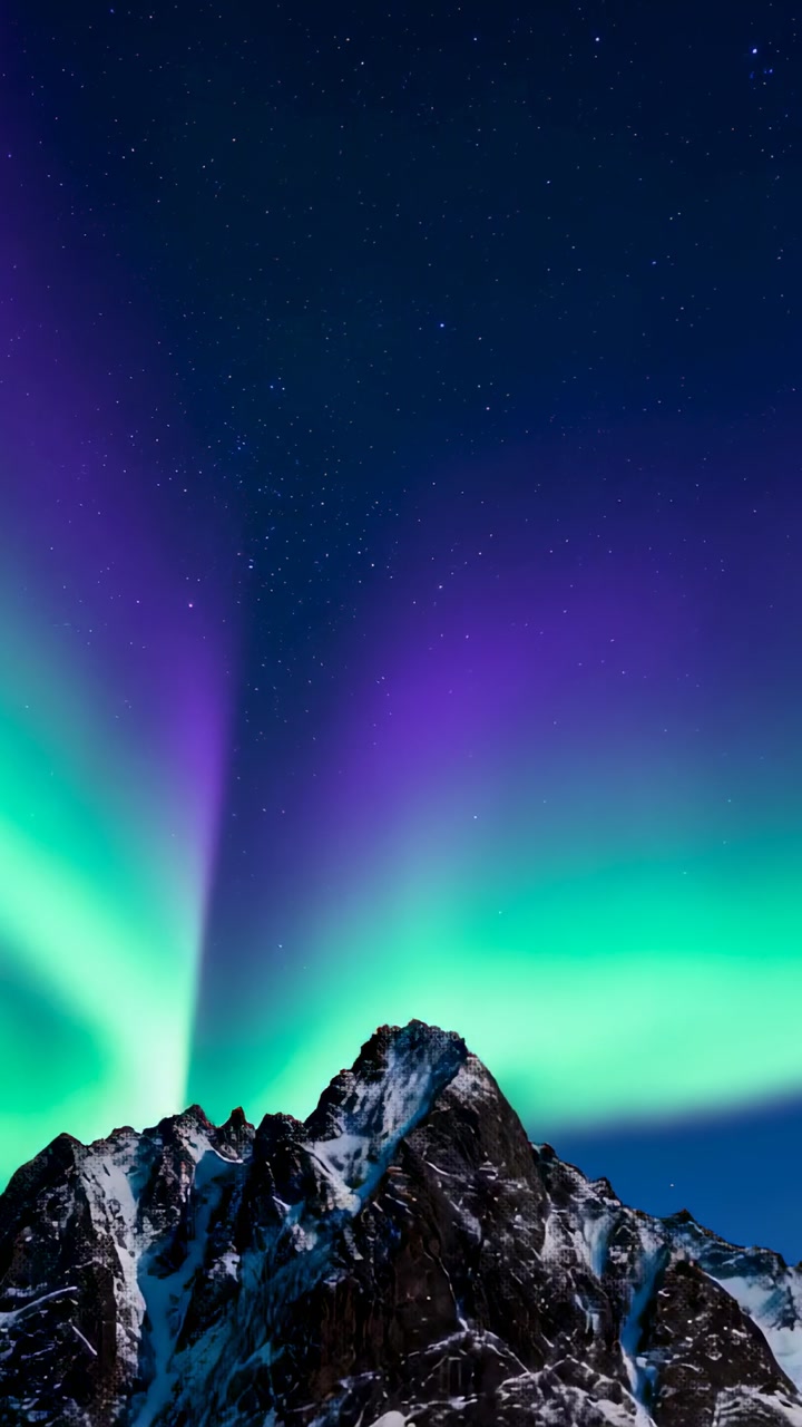 Vertical video: Left-horizon green arc starting aurora sweeping over mountain, showing color shift