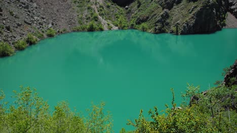 mountain lake of green and blue color urungach. some pine trees. located in uzbekistan, central asia. 13 out of 20  tyanshan mountains